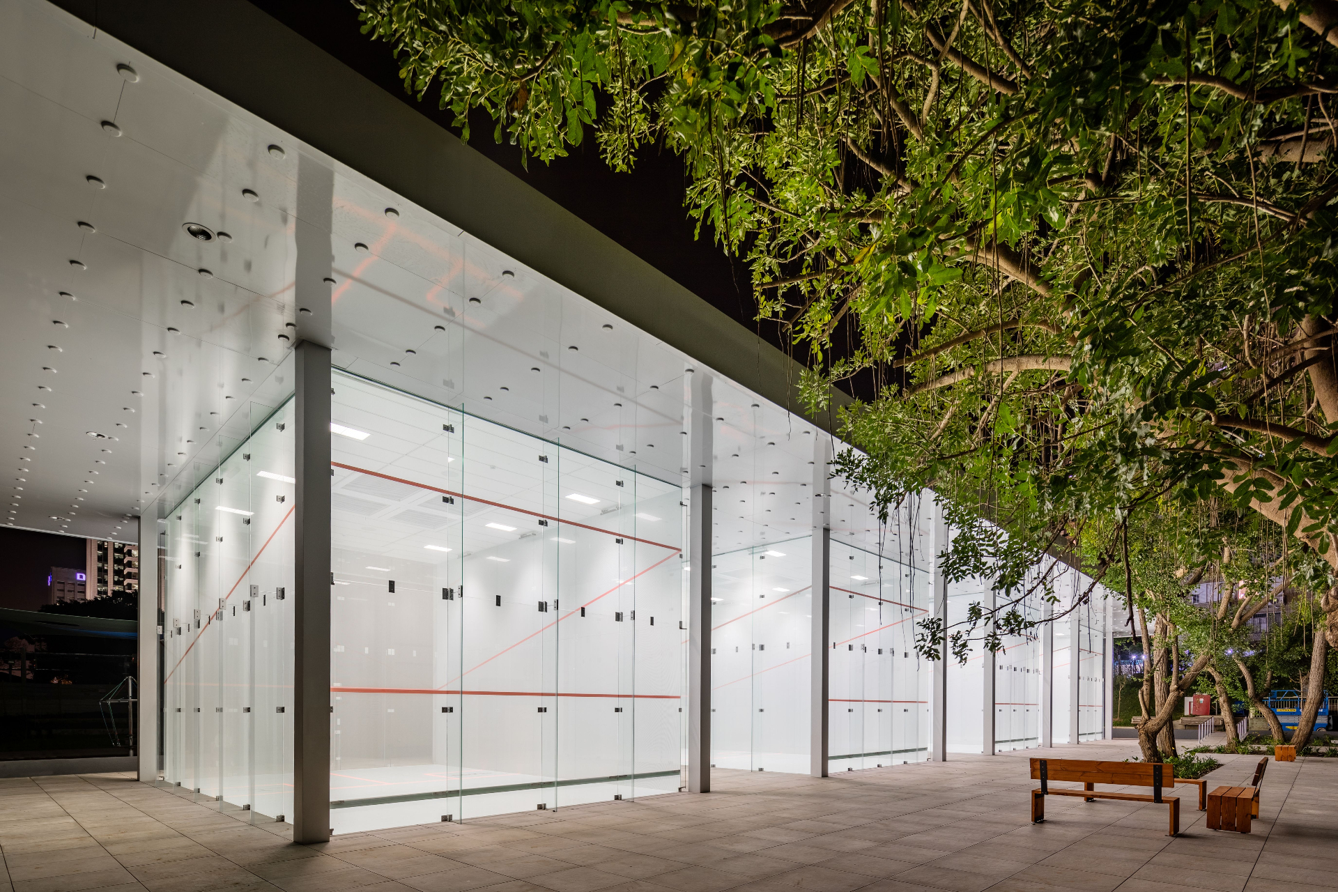 Tpoint glass squash court pavilion at dusk